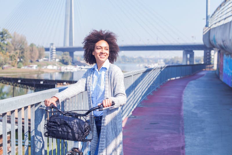 Happy Afro woman with bicycle outdoor portrait royalty free stock photo Happy Afro woman with bicycle outdoor portrait royalty free stock photo
