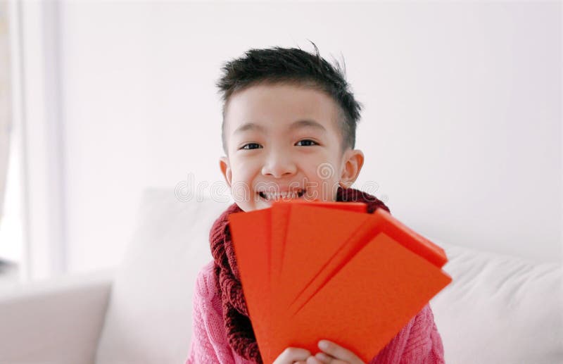 Happy Asian boy showing and holding red envelope. Happy Chinese New Year Concept royalty free stock photo