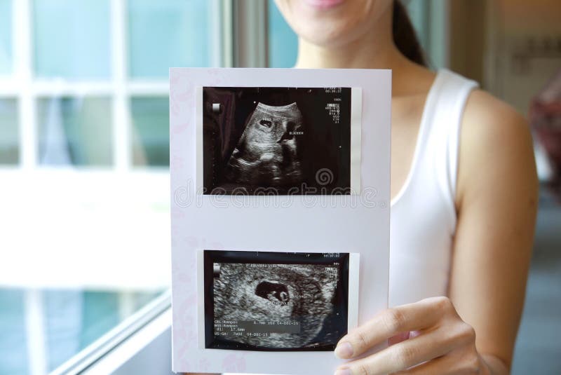 Happy Asian Chinese Woman smiling sweetly from pregnancy news