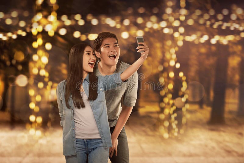 Happy asian couple in love taking selfie photo stock image Happy asian couple in love taking selfie photo stock image