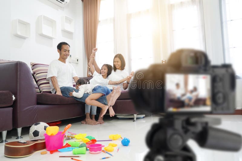 Happy asian family in living room at home, With recording making video royalty free stock photo Happy asian family in living room at home, With recording making video royalty free stock photo