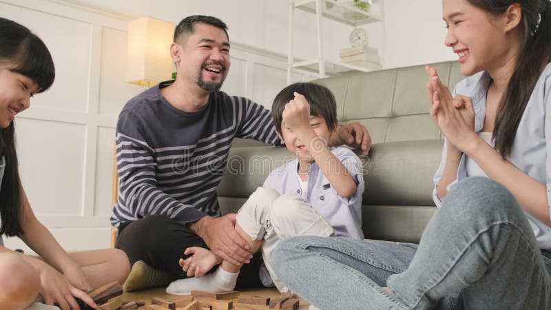 Asian man fun playing video games console with his girlfriend