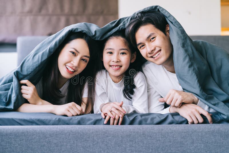 Happy Asian family portrait with mother, father and daughter