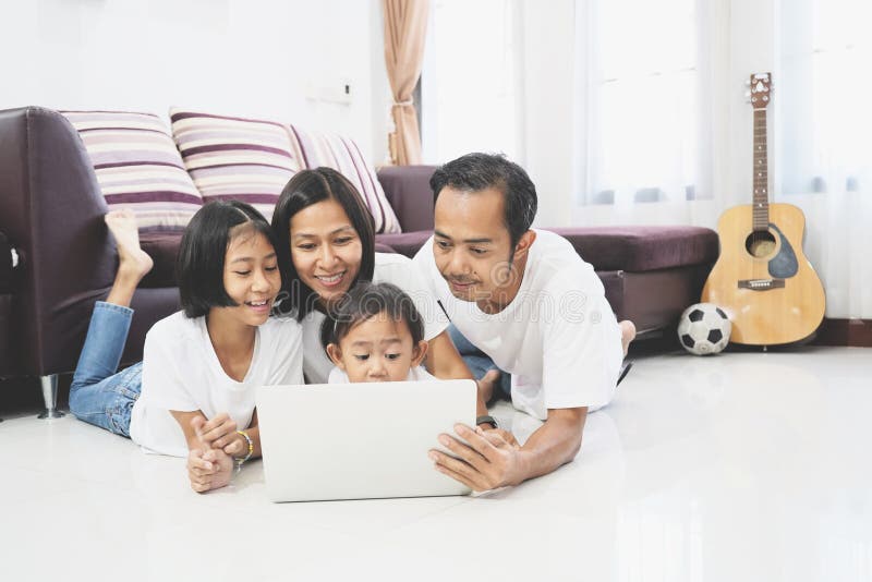 Happy asian family using a laptop computer