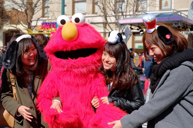 Appy asian girls take shot with Sesame Street Elmo in Universal Studios Japan USJ, Osaka, Japan