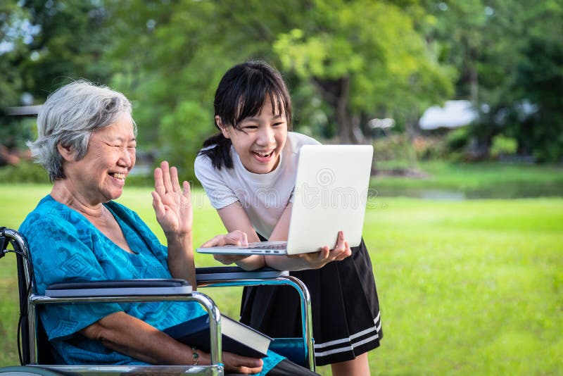 Happy asian granddaughter enjoy smiling and senior grandmother using video conferencing with laptop computer,child girl having royalty free stock photos Happy asian granddaughter enjoy smiling and senior grandmother using video conferencing with laptop computer,child girl having royalty free stock photos