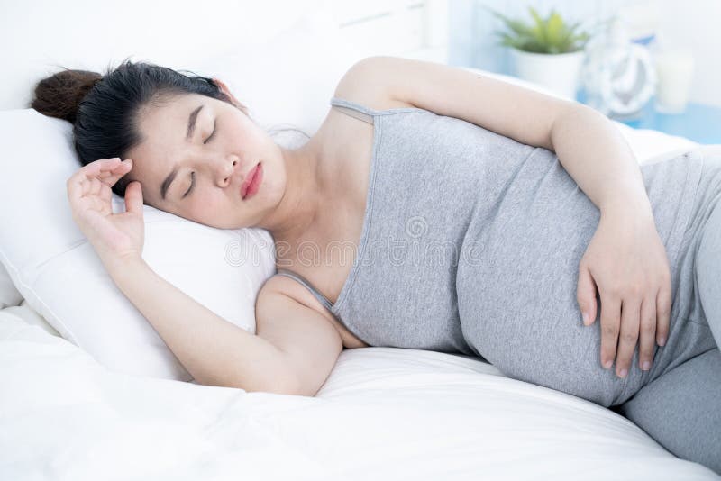 Happy asian pregnant woman sleeping in bed at home. stock photos Happy asian pregnant woman sleeping in bed at home. stock photos