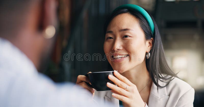 Happy asian woman, friends and coffee at cafe for conversation, catch up or break together. Young female person talking to man with smile or cup of tea for friendly discussion at indoor restaurant. Happy asian woman, friends and coffee at cafe for conversation, catch up or break together. Young female person talking to man with smile or cup of tea for friendly discussion at indoor restaurant.