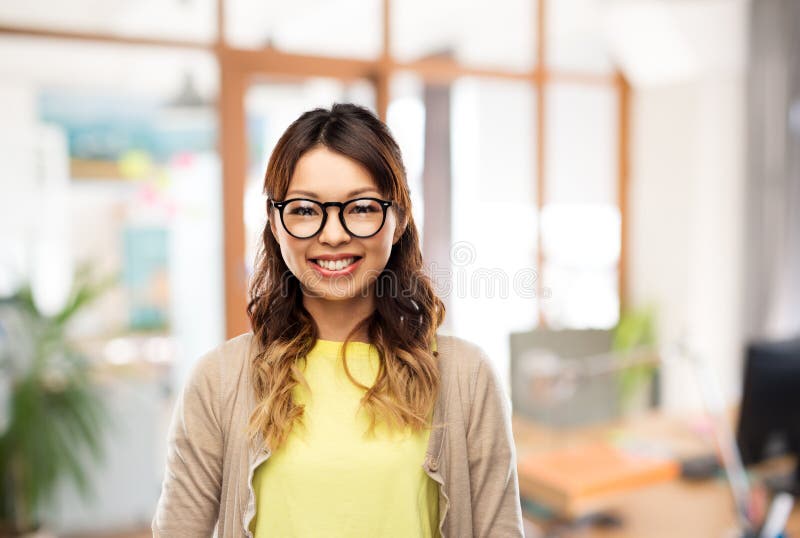 Happy asian woman in glasses or student