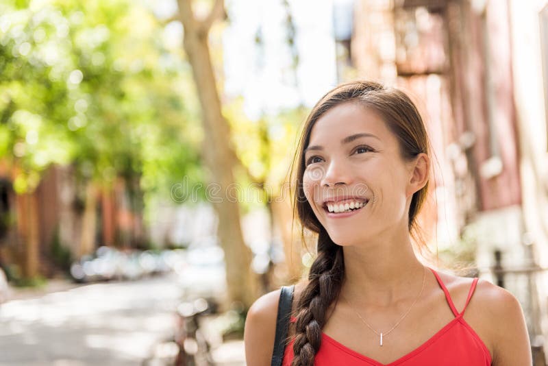 Happy asian woman walking in sunny city street royalty free stock photos Happy asian woman walking in sunny city street royalty free stock photos