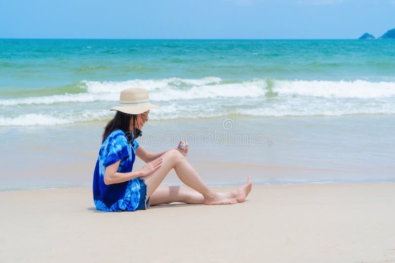 Happy Asian Woman Wear Sunscreen To Protect Her Skin at the Beach ...