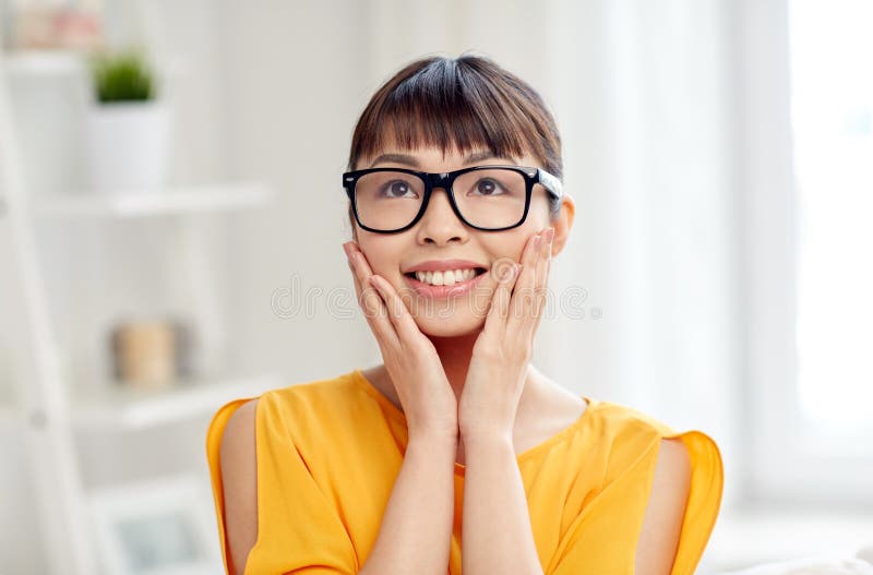 Happy asian young woman in glasses at home