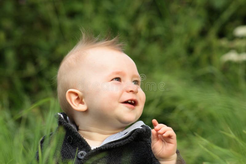 Happy baby boy outdoors