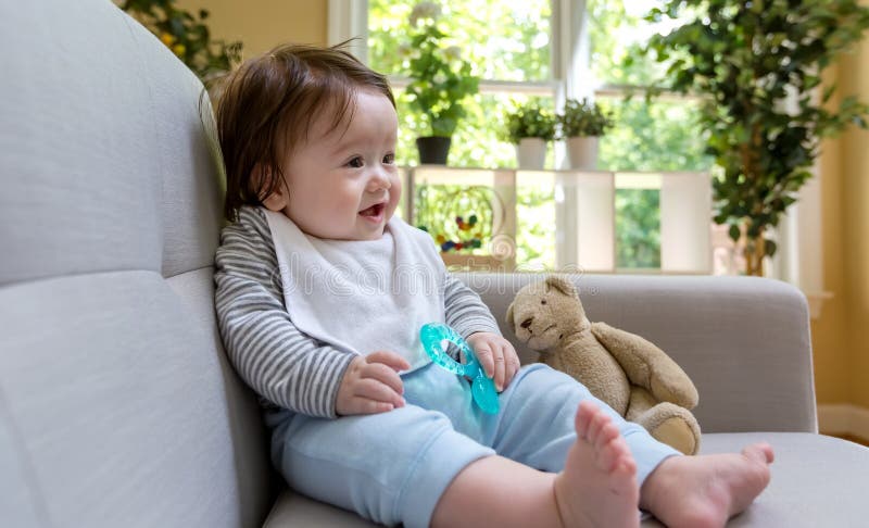 Happy baby boy sitting on a couch royalty free stock photo Happy baby boy sitting on a couch royalty free stock photo