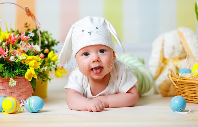Happy baby child with Easter bunny ears and eggs and flowers stock photos Happy baby child with Easter bunny ears and eggs and flowers stock photos