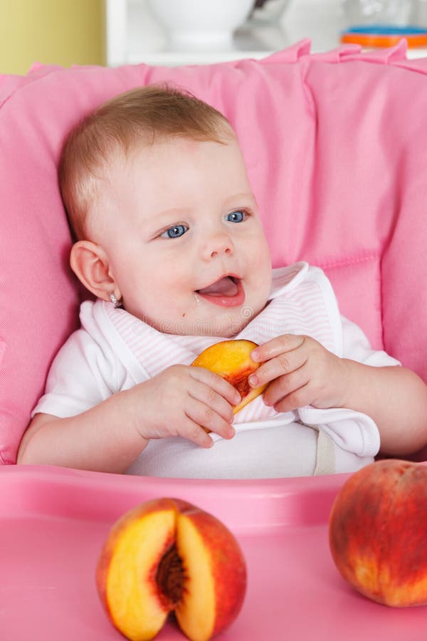 Happy baby eating fruit stock photo. Image of feed, healthcare 49240616