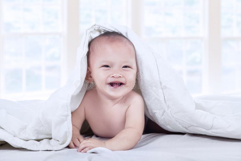 Baby under white blanket stock photo. Image of innocence 