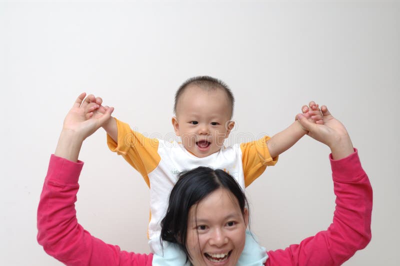 Happy baby on mother s shoulders