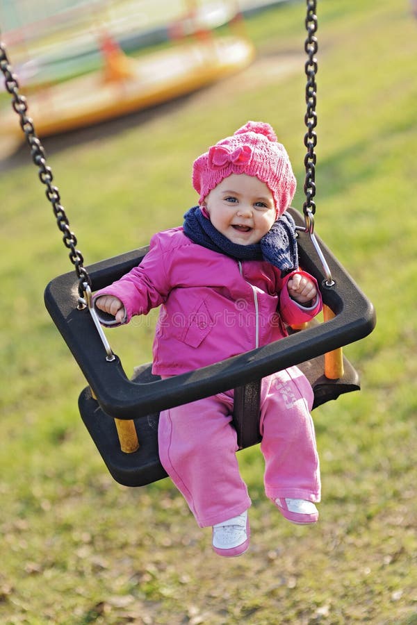 Happy baby playing with the swing