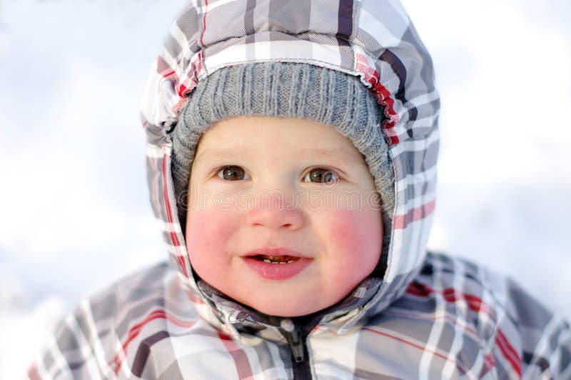 Happy baby with rosy cheeks in winter