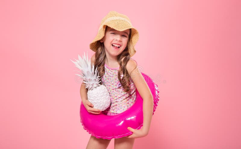 Happy child with pineapples on a colored background stock photos Happy child with pineapples on a colored background stock photos