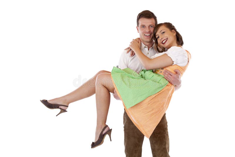 Happy Bavarian man carries woman with dirndl