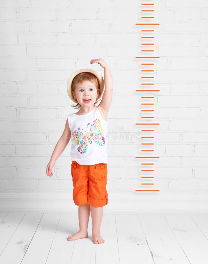 Happy beautiful baby girl growth measures royalty free stock photography Happy beautiful baby girl growth measures royalty free stock photography