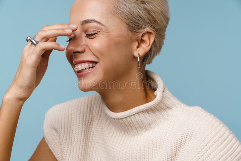 Happy beautiful blonde girl laughing with eyes closed