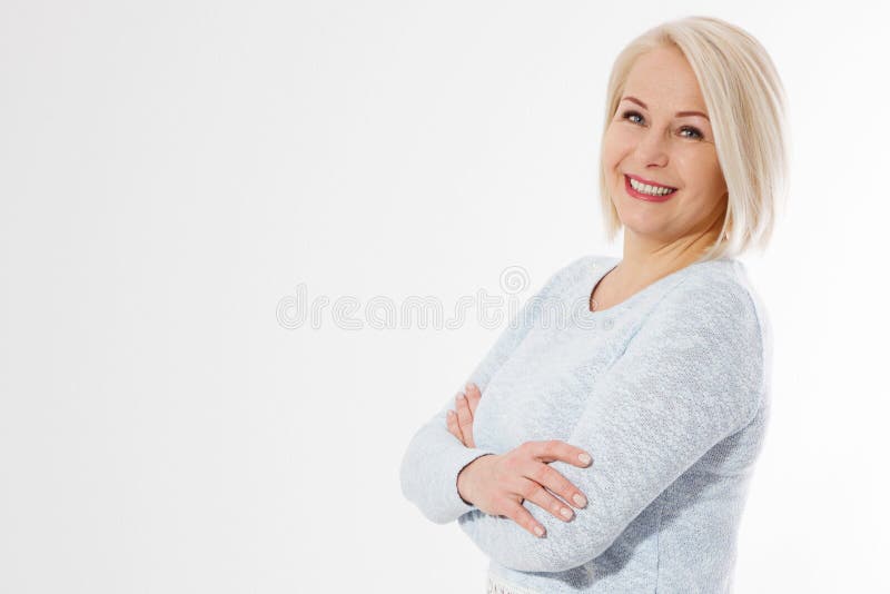 Happy beautiful close up portrait middle age blonde woman. Mid aged healthy female isolated on white background with copy space. Menopause and healthcare. Mature lady wrinkled face. Folded hands