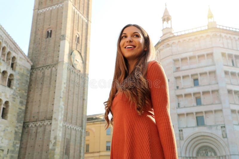 Happy beautiful woman enjoying her vacations in Italy. Smiling traveler girl enjoying her holidays in Parma, Italy royalty free stock images Happy beautiful woman enjoying her vacations in Italy. Smiling traveler girl enjoying her holidays in Parma, Italy royalty free stock images