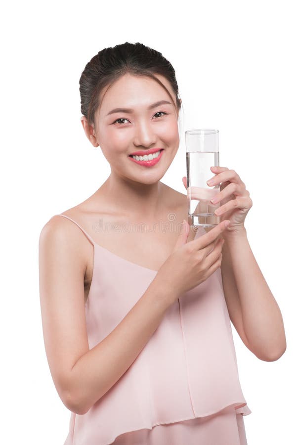 Happy beautiful young vietnamese woman drinking water. royalty free stock photo