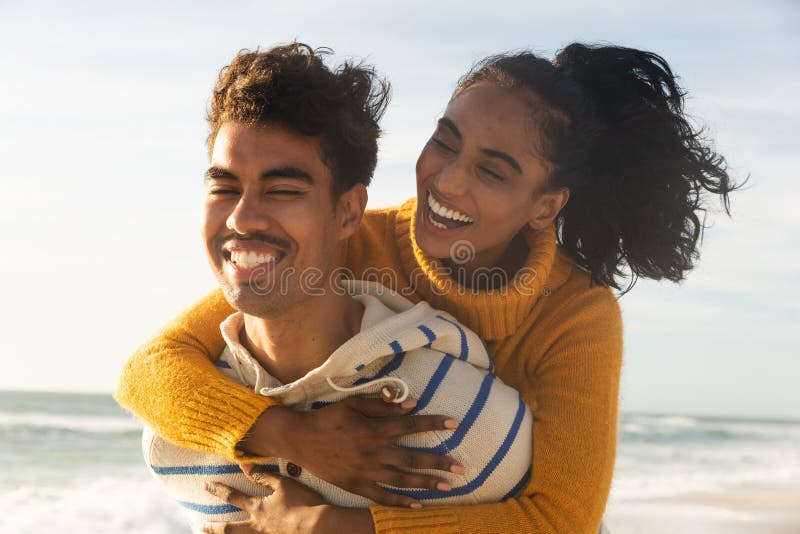 Free Photo  Man giving piggyback ride to woman on the beach