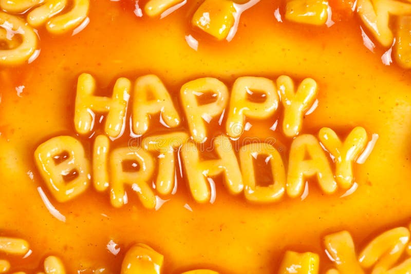 Alphabet shaped pasta forming HAPPY BIRTHDAY in tomato sauce