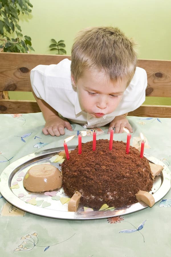 Happy birthday. Little boy is blowing birthday candles stock photography Happy birthday. Little boy is blowing birthday candles stock photography