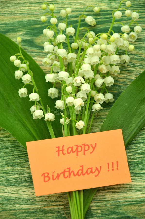 Happy birthday and bouquet of delicate fresh lilies of the valley