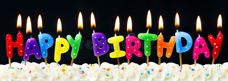 Happy birthday candles against a black background