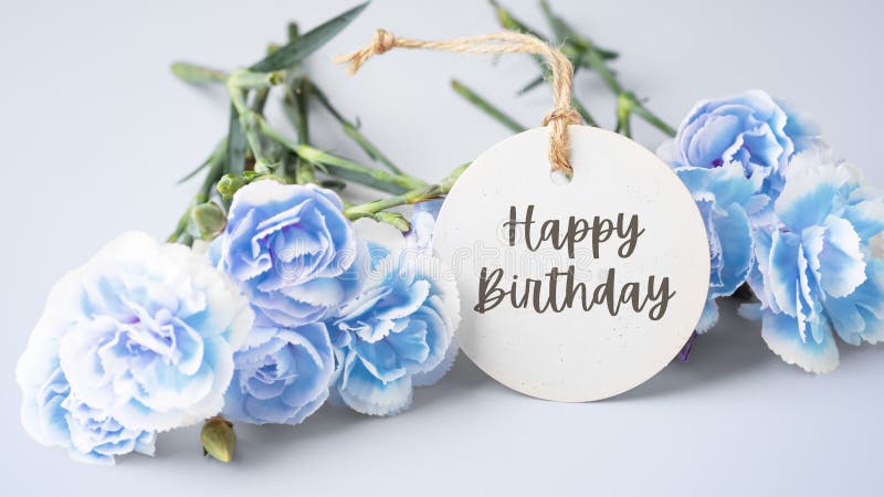 Happy birthday card with blue carnation flowers on blue background. Happy birthday card with blue carnation flowers on blue background