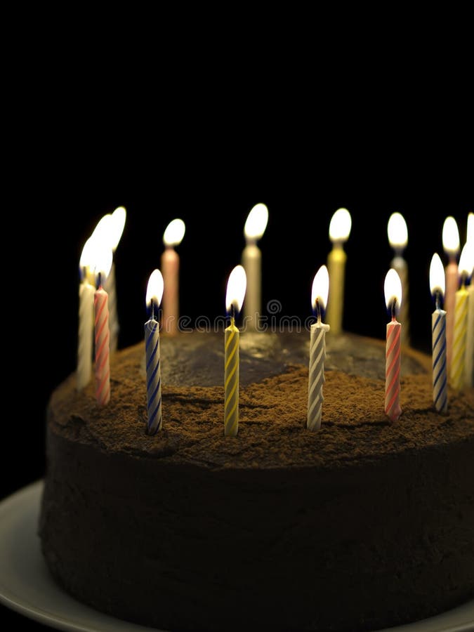 Happy birthday chocolate. Birthday chocolate cake with burning candle on the top. Black background and shallow depth of field royalty free stock image Happy birthday chocolate. Birthday chocolate cake with burning candle on the top. Black background and shallow depth of field royalty free stock image