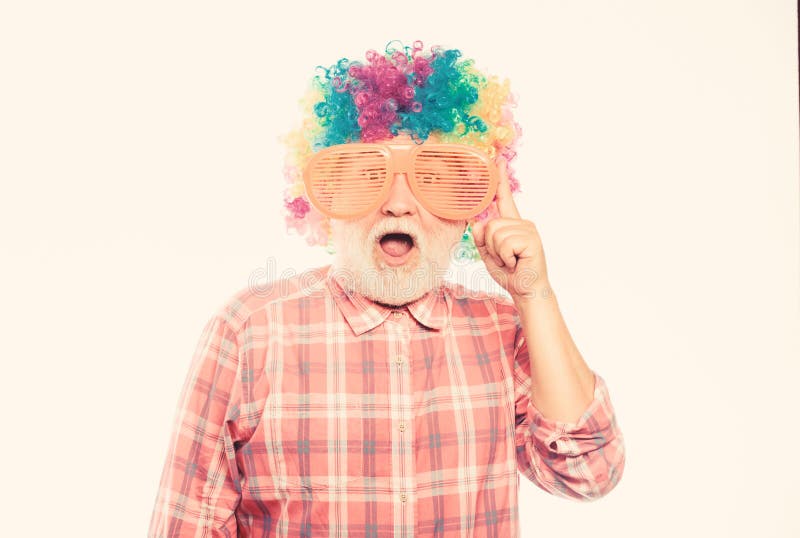 Happy birthday. corporate party. anniversary holiday. mature bearded man in colorful wig and party glasses. happy man royalty free stock photos Happy birthday. corporate party. anniversary holiday. mature bearded man in colorful wig and party glasses. happy man royalty free stock photos