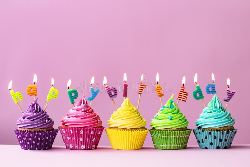 Cupcakes with candles spelling the words happy birthday. Cupcakes with candles spelling the words happy birthday