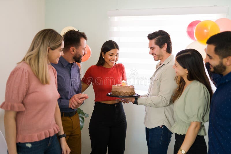 Happy birthday, friend! Loving multiracial friends bringing a delicious chocolate cake with candles to gorgeous young woman for her birthday. Happy birthday, friend! Loving multiracial friends bringing a delicious chocolate cake with candles to gorgeous young woman for her birthday