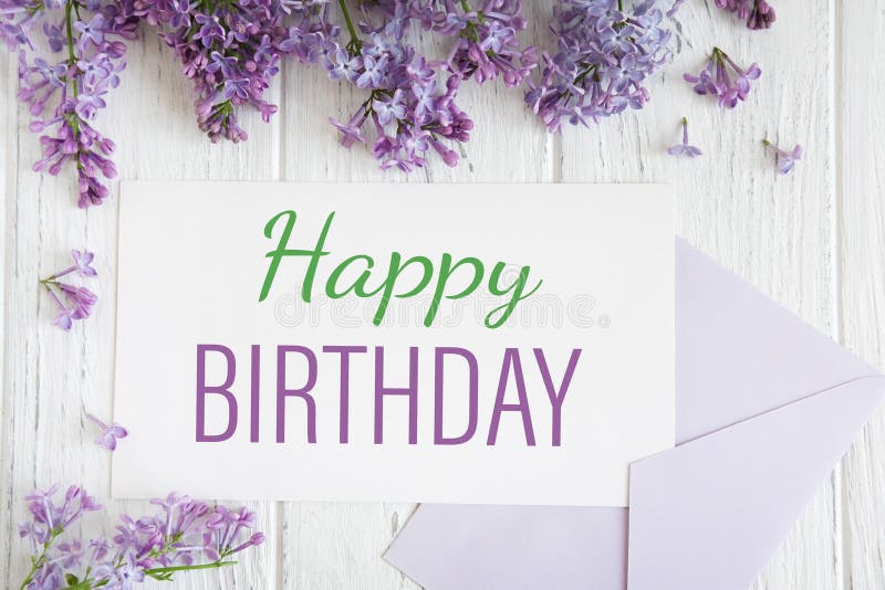 Happy birthday greeting card with lilacs. Spring card with branches of lilac on an all-round wooden background with a postal stock photo Happy birthday greeting card with lilacs. Spring card with branches of lilac on an all-round wooden background with a postal stock photo
