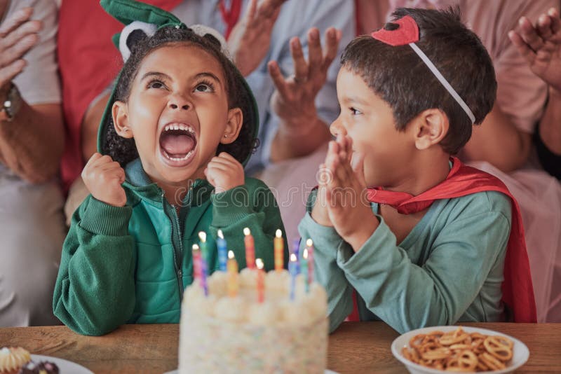 Happy birthday, party and children in halloween costume to celebrate young and fun girls special day together. Cake