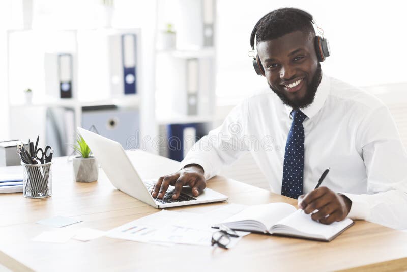 Happy black businessman learning foreign language online stock images