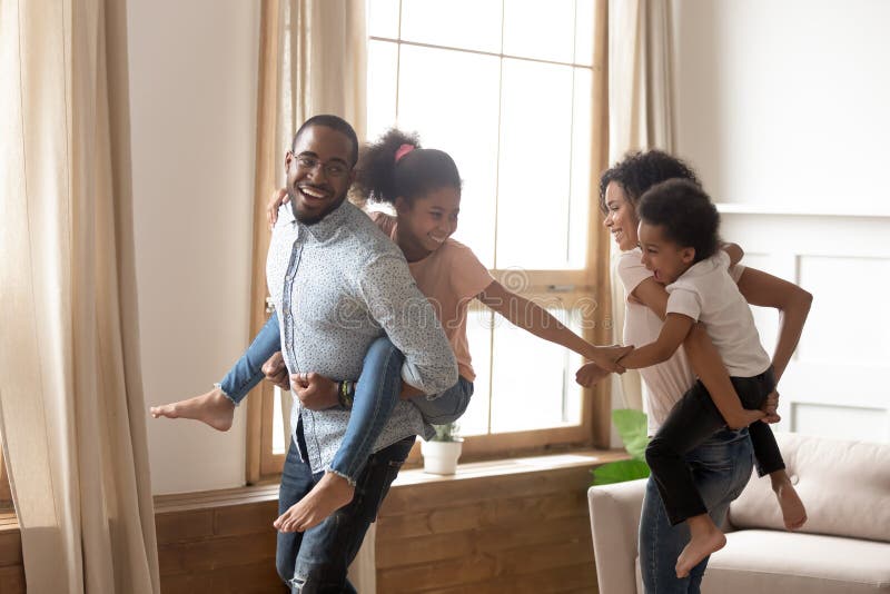 Cheerful african american father giving son piggyback ride outdoors  smiling, Happiness family concepts 6774671 Stock Photo at Vecteezy