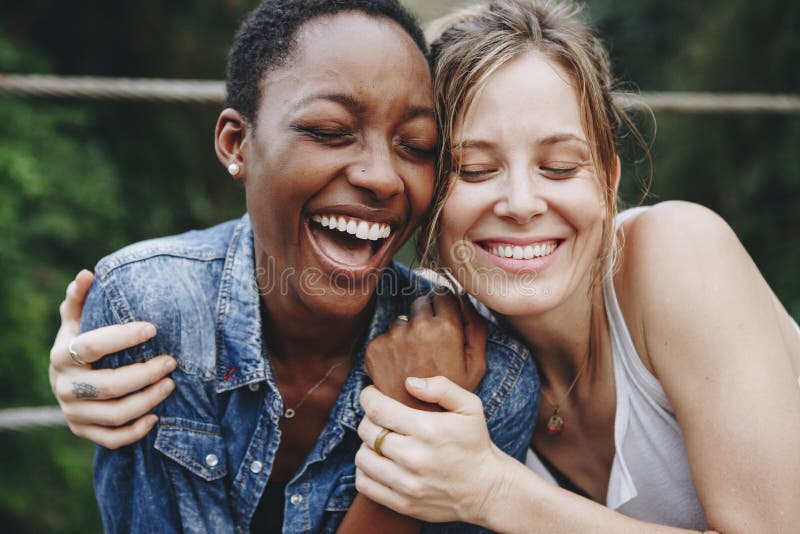 Happy black woman laughing with her friend