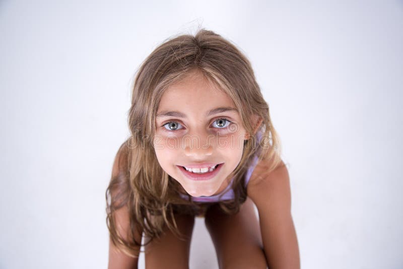 Happy blond girl looking at the camera from front stock photo