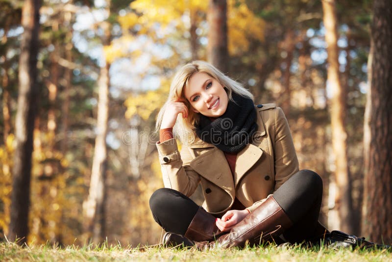 Happy blond fashion woman in autumn forest