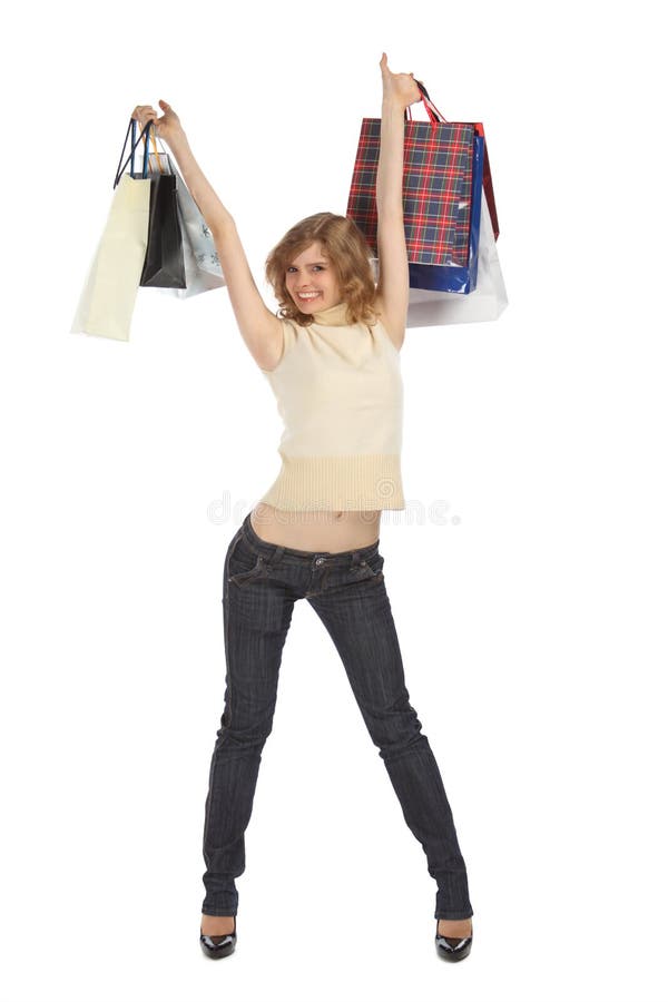 Happy blonde holds paper bags in rised hands