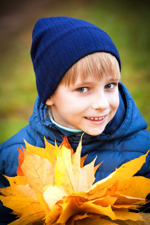 Happy boy in autumn park